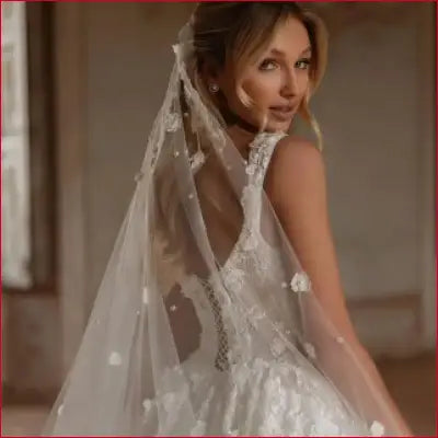 Elegant wedding dress with veil featuring luxurious lace appliqué and sexy backless design
