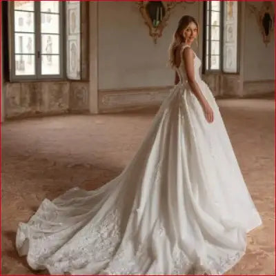 Elegant white wedding dress with spaghetti straps and lace applique for a stunning bridal look