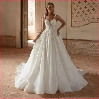 Elegant white wedding dress with lace applique and sexy backless design