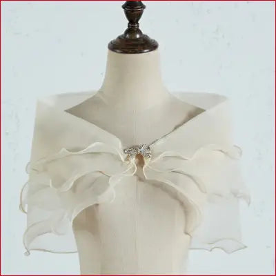 Ivory bridal shawl with ruffles and brooch featuring removable shoulder straps