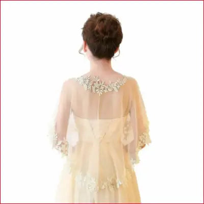 Woman wearing a lace shawl with floral-trimmed sheer capelet for summer casual or wedding