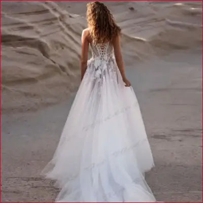 Elegant white wedding dress with lace appliques and off-the-shoulder design for brides