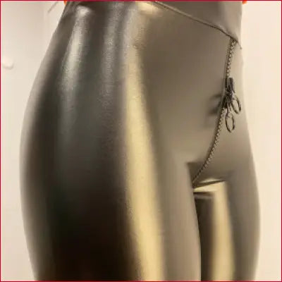 Metallic mannequin torso showcasing Black Faux Leather Handmade Leggings with Crotch Zipper Triangle Design