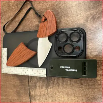 Survival gear flat lay featuring iPhone 14 Black Case with Box Opener and Frame Ruler
