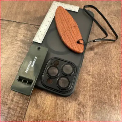 Black iPhone 14 case with accessories including box opener and frame ruler