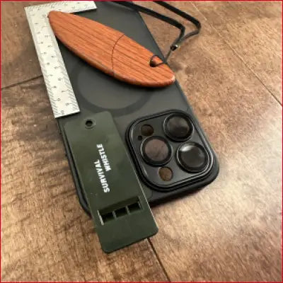 Black iPhone 14 case with accessories including box opener and frame ruler