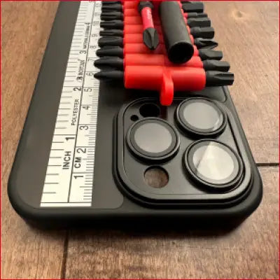 Black case for iPhone 14 Plus with screwdriver bits, ruler, box cutter in sleek design