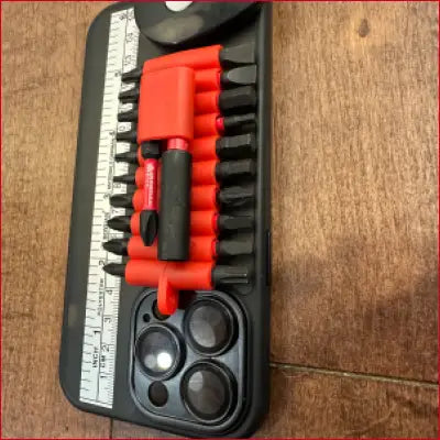 Black phone case with screwdriver bit set and box cutter for iPhone 14 Plus Black Case