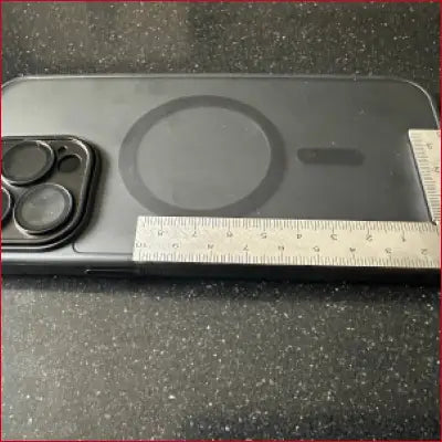 Black iPhone 14 Pro Max with stainless frame and MagSafe ring featuring frame ruler