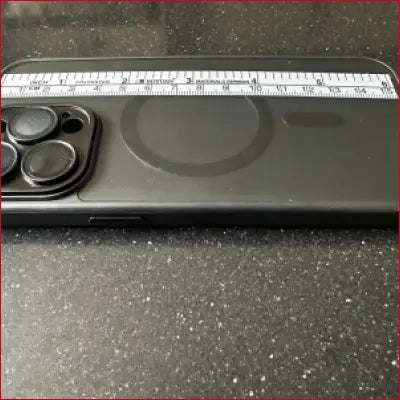 Black iPhone 15 Pro case with silver ruler and camera lenses for precise measurement