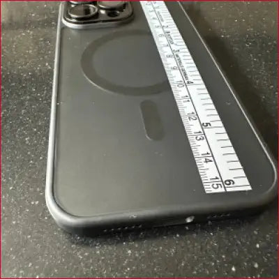 Black smartphone with iPhone 15 Pro Black Case Silver Ruler and measuring tape
