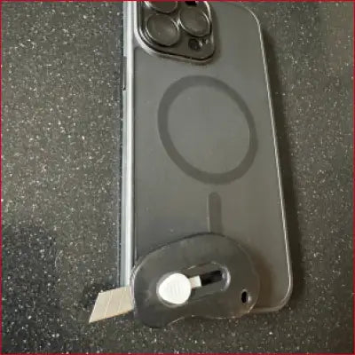Clear iPhone 16 Plus Black Case with MagSafe ring and box cutter utility knife