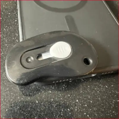 Black phone grip with sliding button on iPhone 16 Plus Black Case Box Cutter