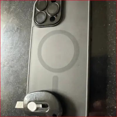 Smartphone with MagSafe case in iPhone 16 Plus Black Case Box Cutter featuring a plus black design