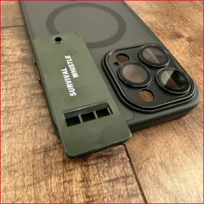 Olive green survival whistle on iPhone 16 Plus black case for outdoor safety