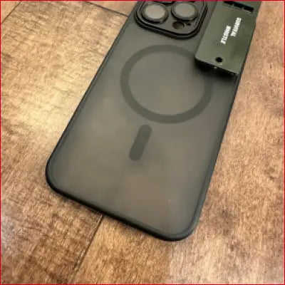 Gray phone case with MagSafe ring and survival whistle for iPhone 16 Plus black case