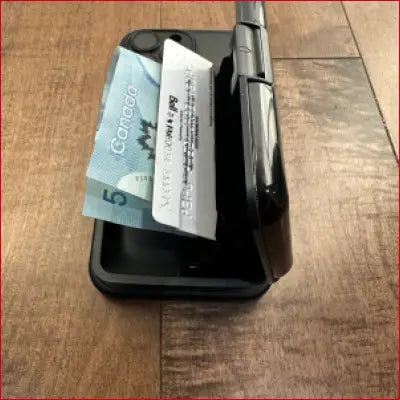 Black case for iPhone 16 Pro Max with foldable card holder and cash illustration