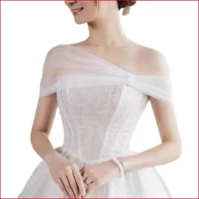 Elegant white off-the-shoulder wedding dress with bling crystals and lace details