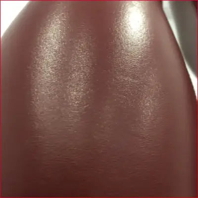 Close-up of dark brown glossy sheen on Red Wine Faux Leather Leggings for style