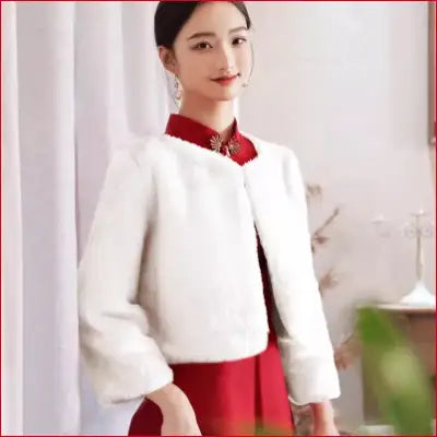 Woman in red dress with white faux fur bolero, perfect for white wedding or winter events