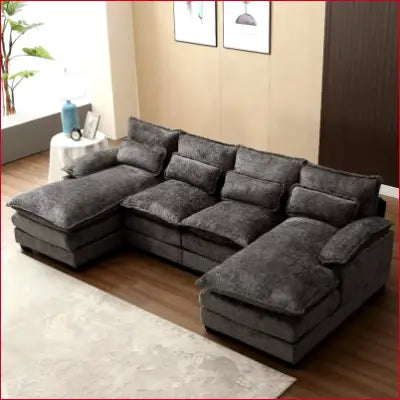 Gray sectional sofa couch with plush cushions in a modern chenille U shaped design