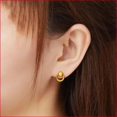 Gold crescent moon-shaped earring styled with stunning round stud earrings