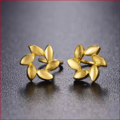 Gold stud earrings featuring petal-like designs in 24k gold floral studs