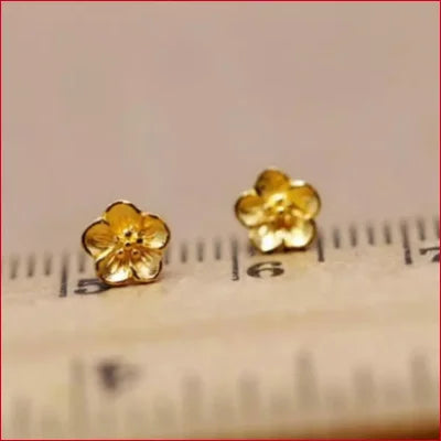 Gold flower-shaped stud earrings in 24K Solid Gold Fine Jewelry collection