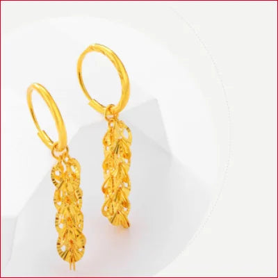 Gold hoop drop earrings featuring intricate leaf designs in 24k pure solid gold