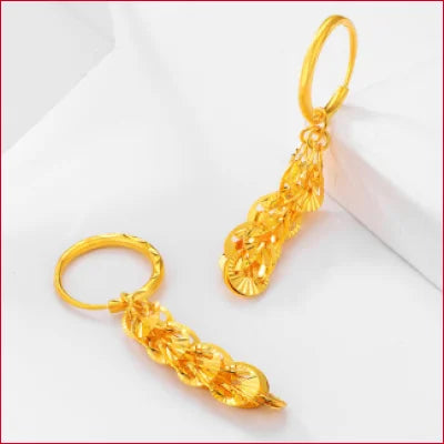 Gold hoop drop earrings featuring intricate leaf designs in pure solid 24k gold