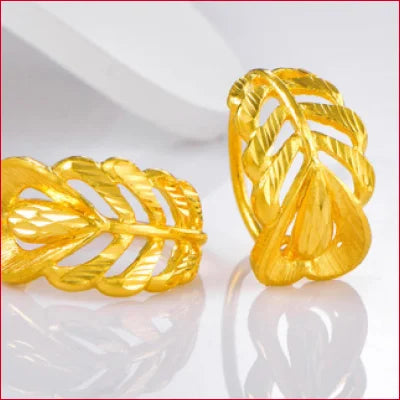 Gold leaf-shaped rings with intricate designs in 24 Karat Pure Gold Heart Leaf Earrings