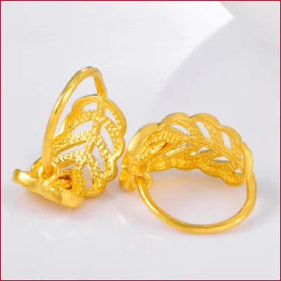 Gold rings featuring intricate leaf designs from 24 Karat Pure Gold Heart Leaf Earrings