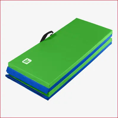 Folded green and blue exercise mat with handle for home workouts and padded protection