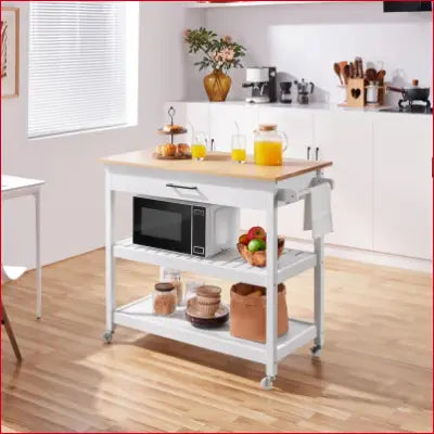 White kitchen island cart on wheels with solid wood top and three spacious storage tiers