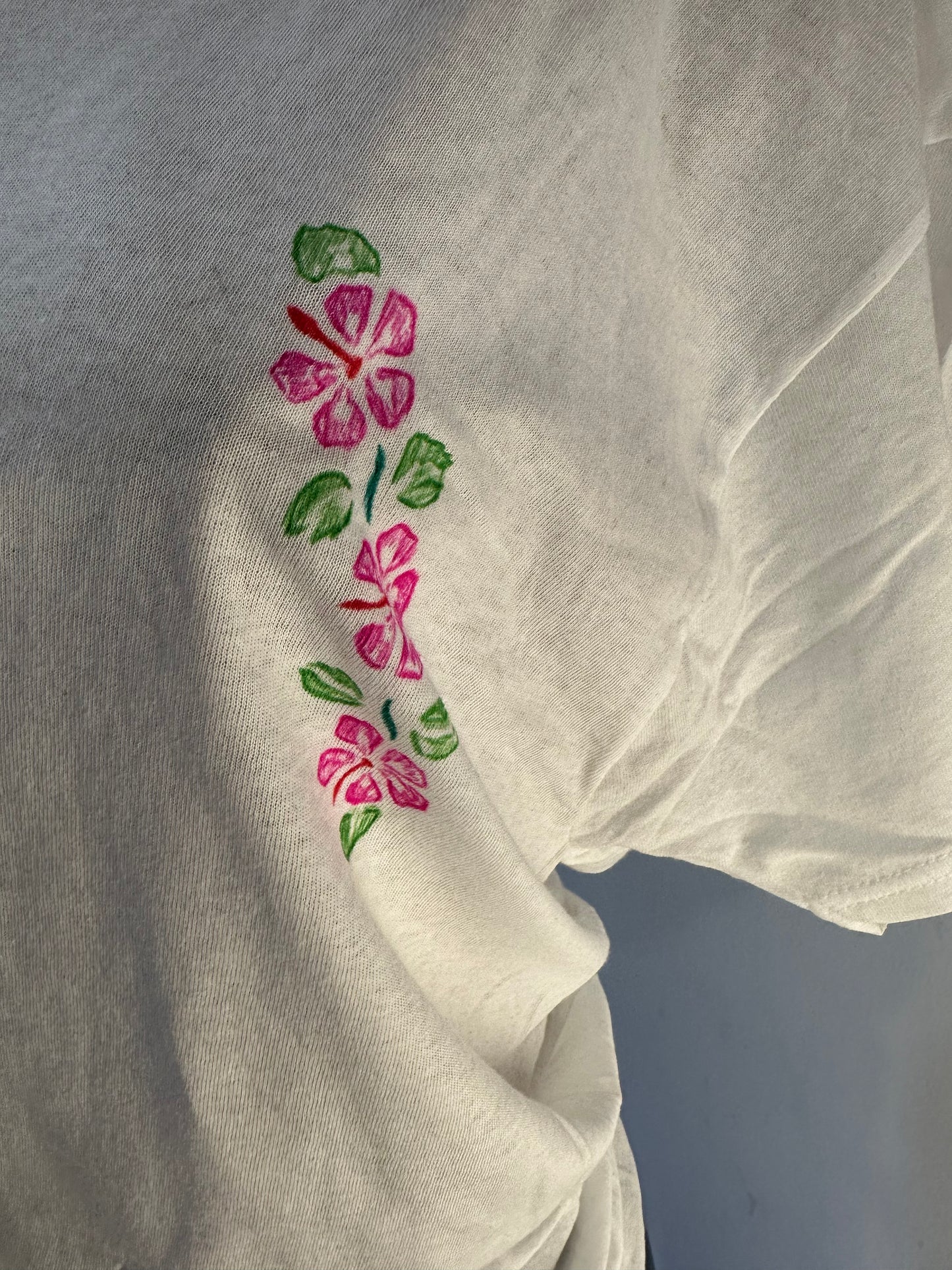 Handmade white women’s V-neck cotton T-shirt with pink floral embroidery on sleeve