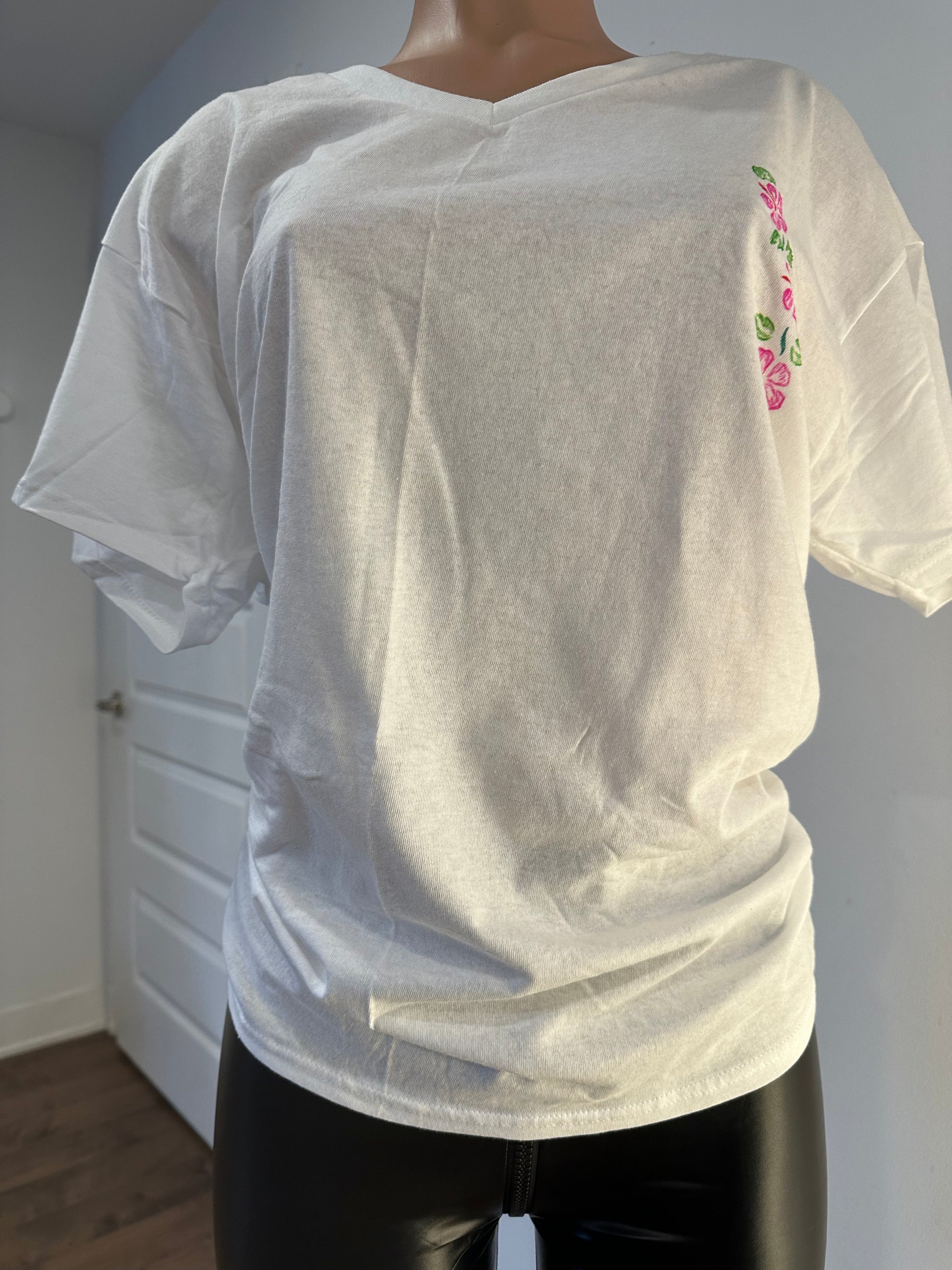 Handmade white women’s V-neck cotton t-shirt with floral design on the chest