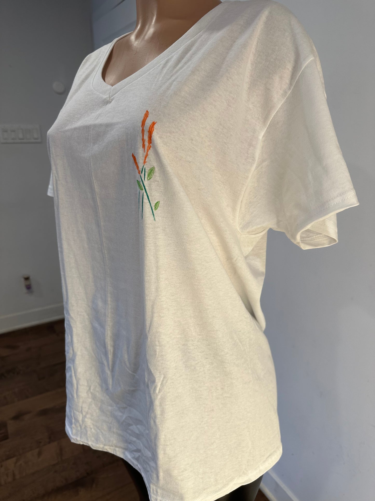 Handmade white V-neck cotton women’s T-shirt with small embroidered flower design