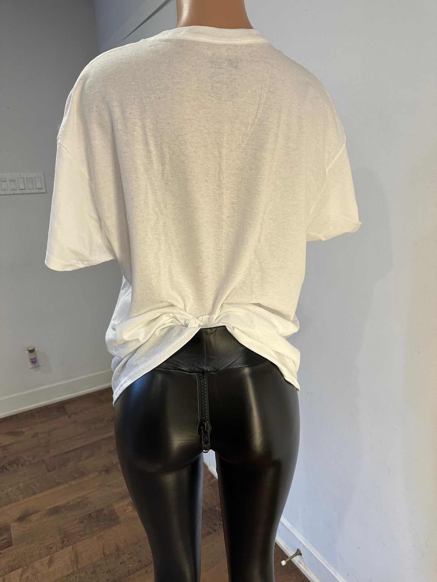 Cream-colored oversized t-shirt tied at the back with shiny black leggings, handmade white women’s