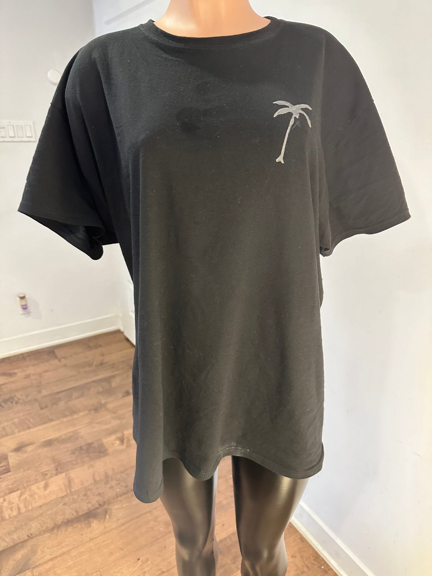 Handmade black crew neck men’s t-shirt featuring a palm tree drawing on gray fabric