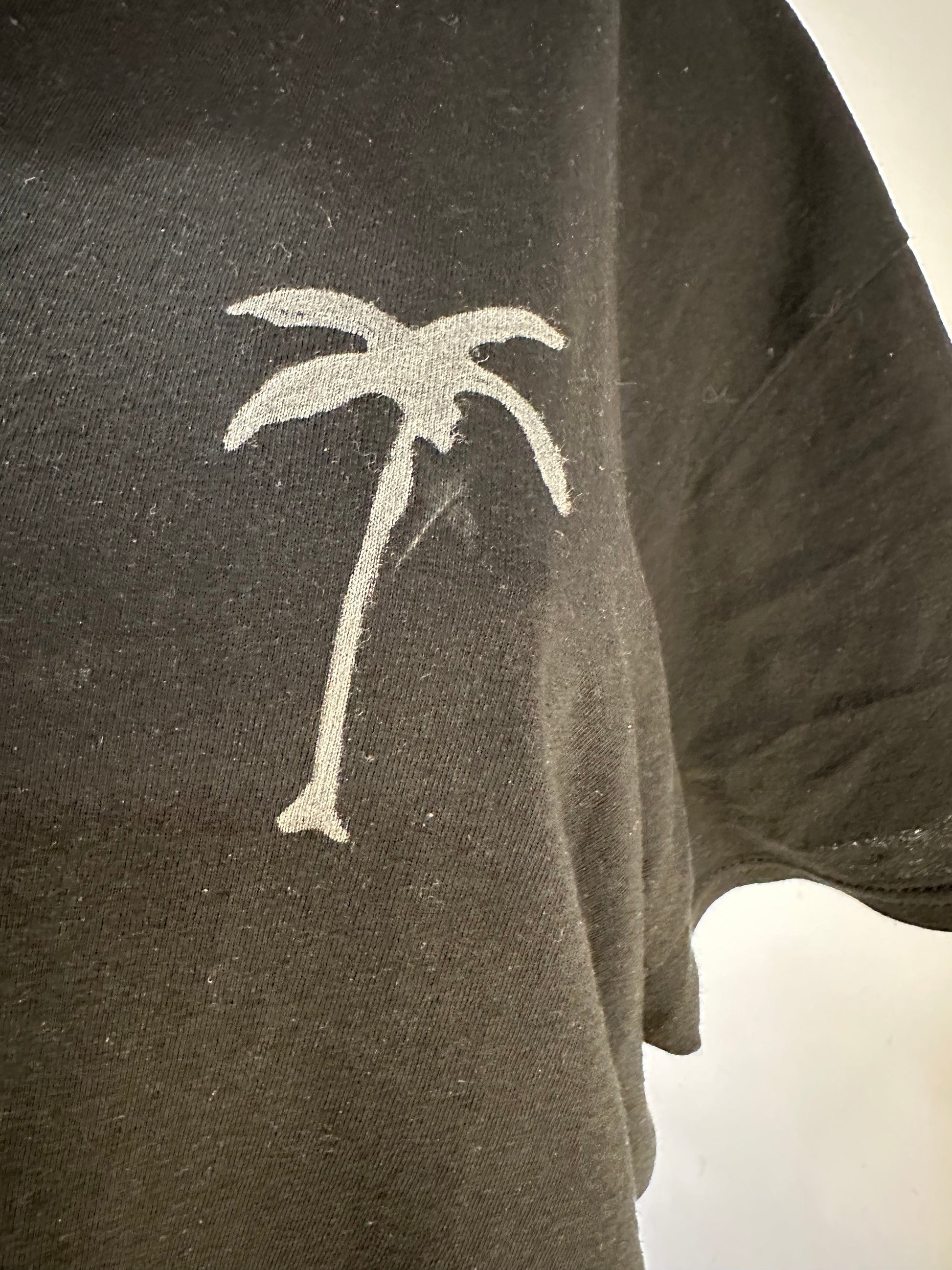 Handmade black crew neck men’s t-shirt featuring a white palm tree drawing design