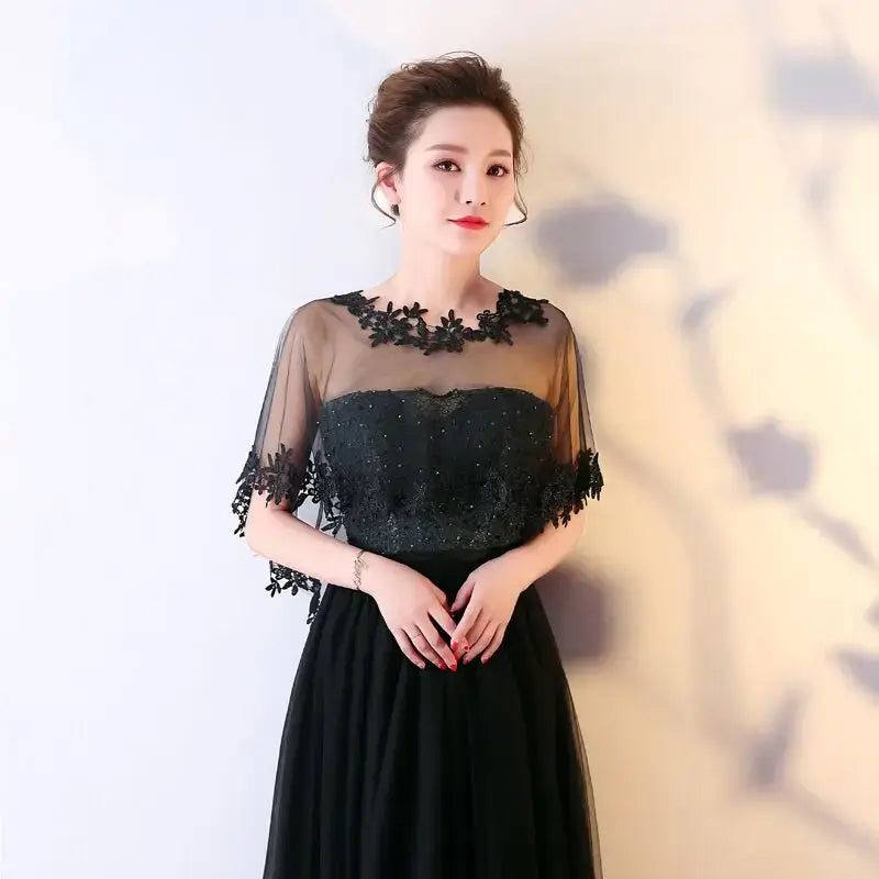 Elegant black bridal evening dress with lace shawl and pearl cape for sophisticated events