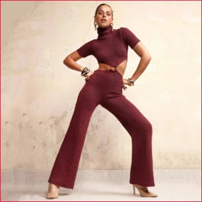 Woman in burgundy turtleneck cutout knitted two-piece outfit with wide-leg pants