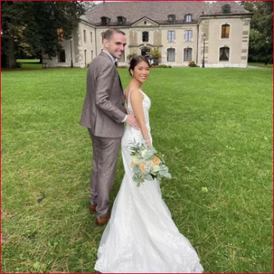 Newlywed couple on a lawn in a Backless Sleeveless V-Neck Wedding Dress Bridal Gown