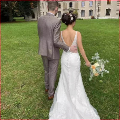 Newlywed couple in a Backless Sleeveless V-Neck Long Train Wedding Dress Bridal Gown