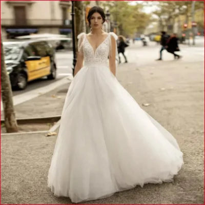 Traditional Tulle Backless Wedding Dress featuring plunging V-neckline and voluminous skirt