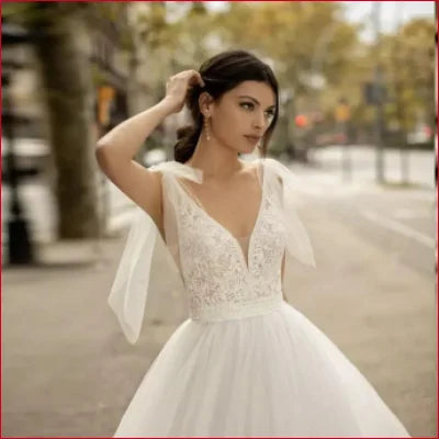 Traditional Tulle Backless Wedding Dress with plunging lace bodice and voluminous skirt