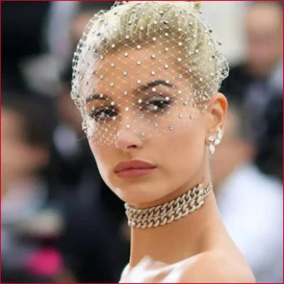 Woman with platinum blonde hair in a jeweled headpiece and Birdcage Bridal Veil Hair Hoop