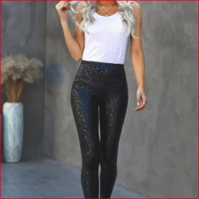 Shiny black leopard women’s leggings with a white tank top, sizes S-XL available