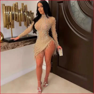 Woman in a beige Rhinestones Faux Pearls Sheer Mesh Bodycon Dress with high slit