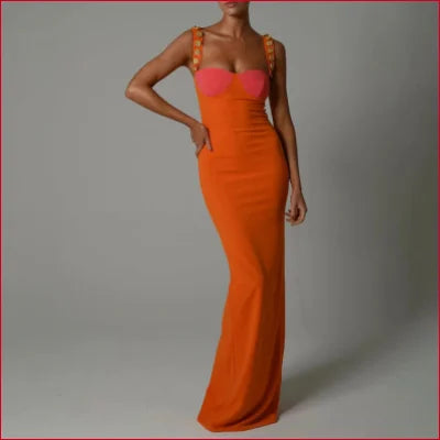 Long, form-fitting orange evening gown with spaghetti straps, backless sleeveless design